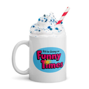 white mug with pink funny times logo on a blue background